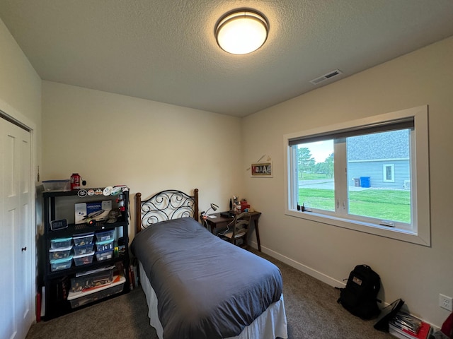 carpeted bedroom with a textured ceiling