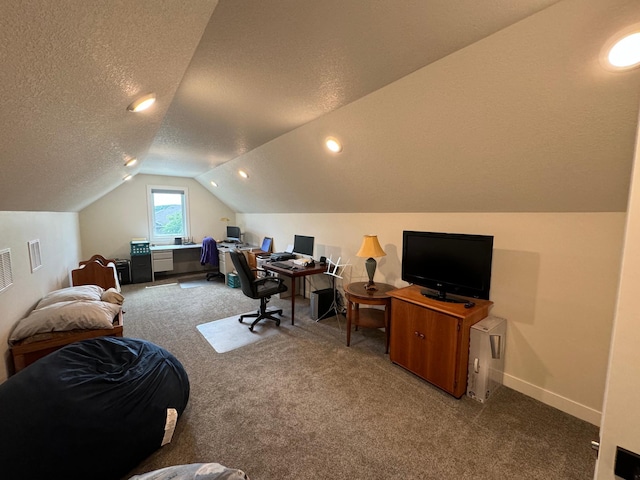 carpeted office space with vaulted ceiling and a textured ceiling