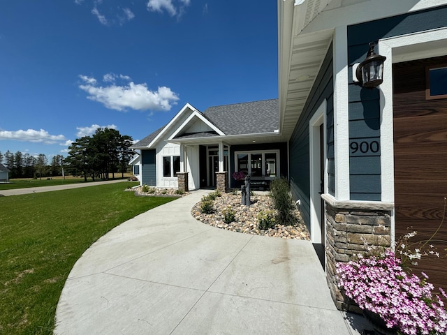 property entrance with a lawn