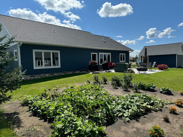 rear view of property with a lawn and a patio area