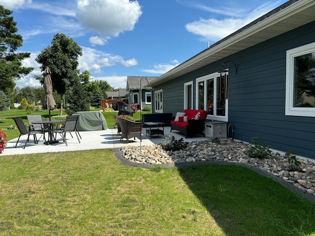 view of yard with outdoor lounge area, a playground, and a patio