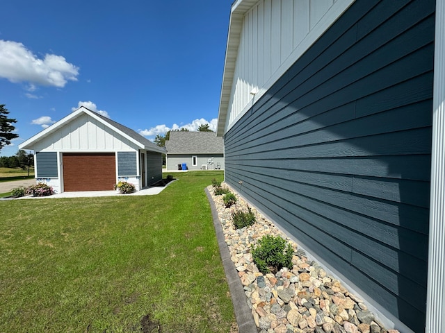 view of property exterior featuring a garage and a lawn