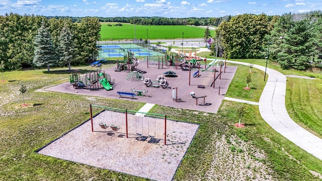 surrounding community featuring a yard, tennis court, and a playground