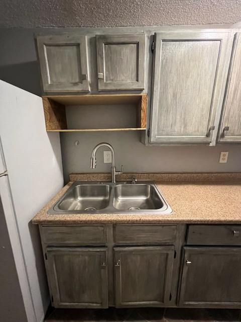 kitchen featuring sink and white fridge