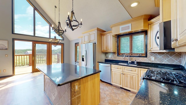 kitchen featuring a kitchen island, decorative light fixtures, sink, high vaulted ceiling, and appliances with stainless steel finishes