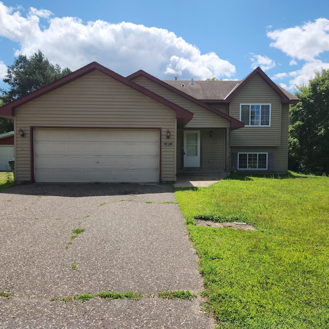 view of front of property featuring a garage and a front yard