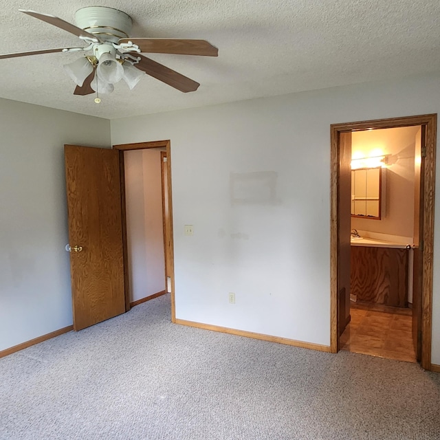 unfurnished bedroom with ceiling fan, carpet, and ensuite bath