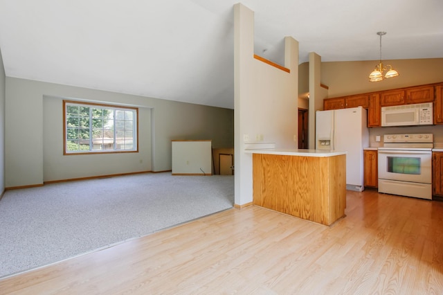 kitchen featuring light hardwood / wood-style floors, a chandelier, kitchen peninsula, white appliances, and hanging light fixtures