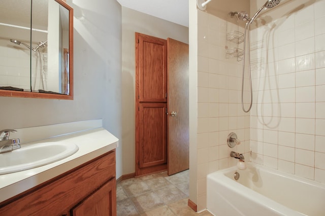 bathroom featuring tiled shower / bath, vanity, and tile patterned floors