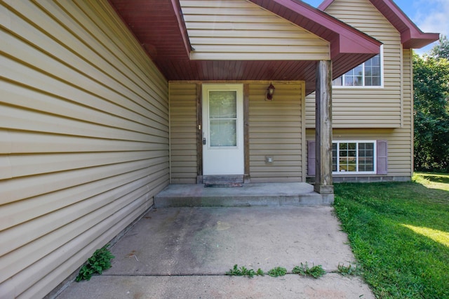 doorway to property featuring a lawn