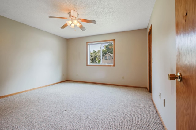 empty room featuring carpet, a textured ceiling, and ceiling fan