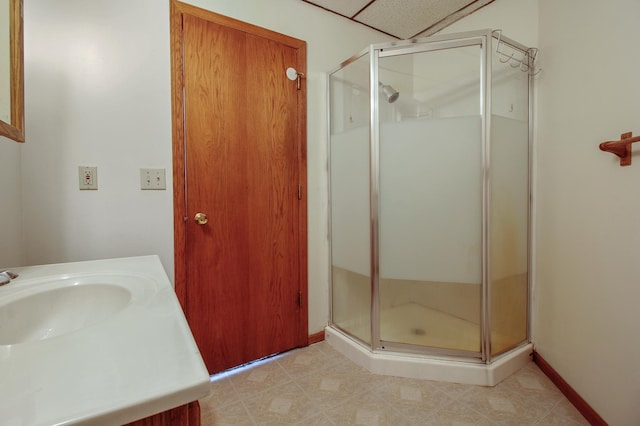 bathroom with tile patterned floors, vanity, and walk in shower