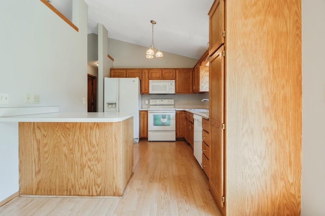 kitchen with kitchen peninsula, white appliances, sink, and light wood-type flooring