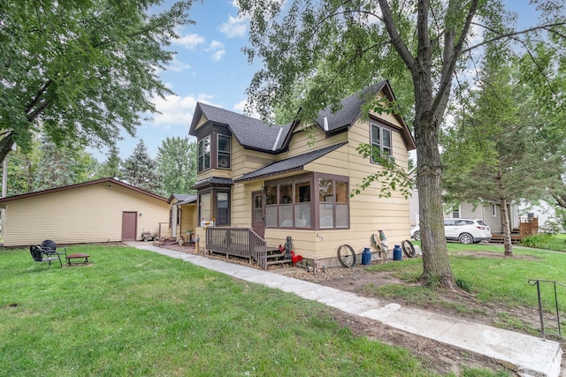 back of house with a lawn and a deck