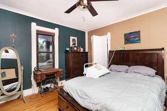 bedroom featuring wood-type flooring, ceiling fan, and crown molding