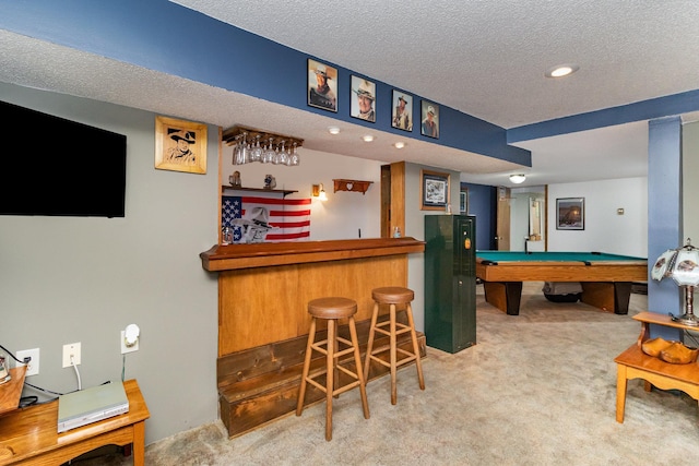 recreation room with a textured ceiling, light colored carpet, billiards, and bar