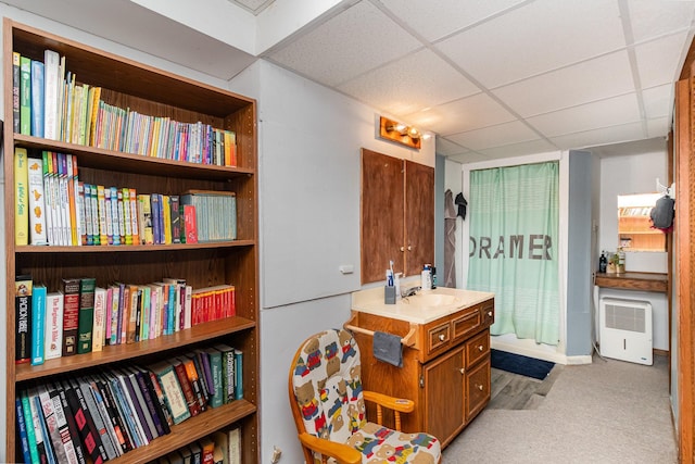 interior space with vanity and a paneled ceiling