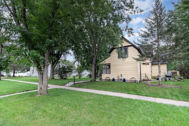 view of side of home featuring a lawn