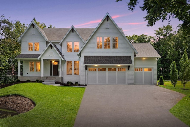 view of front facade featuring a garage and a lawn