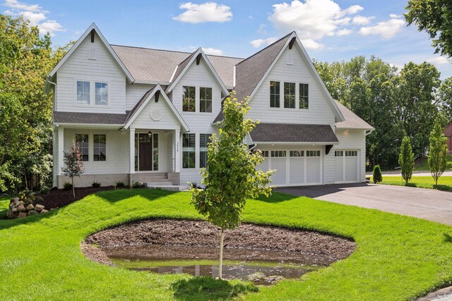 view of front facade featuring a garage and a front lawn