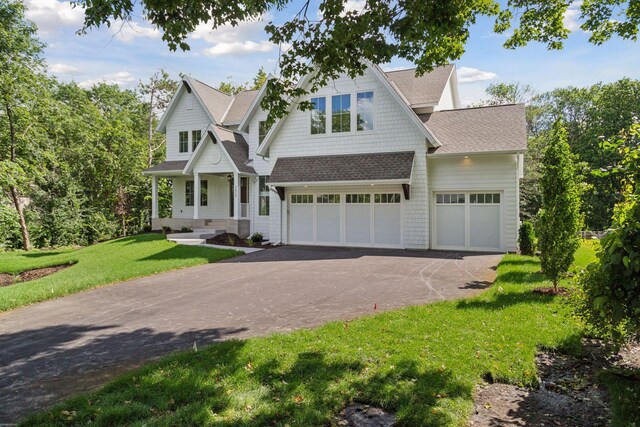 craftsman-style house with a front lawn and a garage