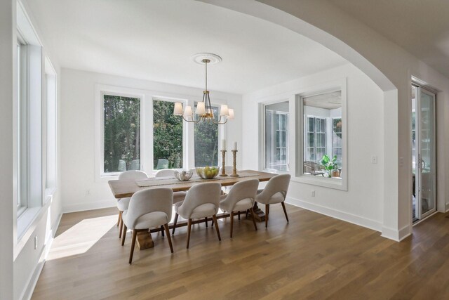 dining space with a chandelier and wood-type flooring