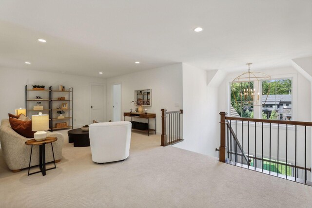 living room with a chandelier and light colored carpet