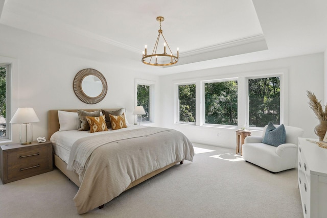 bedroom with a notable chandelier, a raised ceiling, and light colored carpet