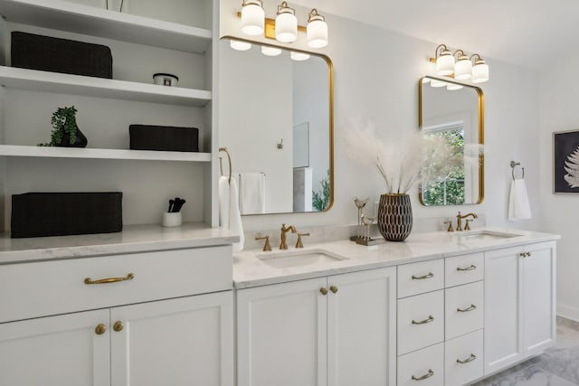 bathroom with tile patterned floors, built in shelves, and double sink vanity