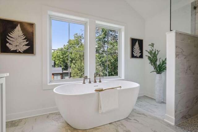 bathroom featuring lofted ceiling, a bath, and tile patterned floors