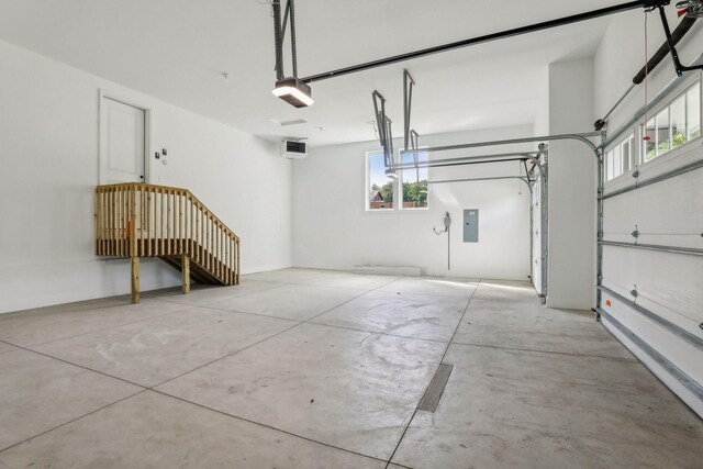 garage with a garage door opener and electric panel