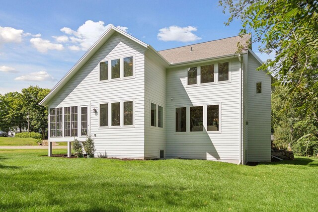 rear view of house with a yard