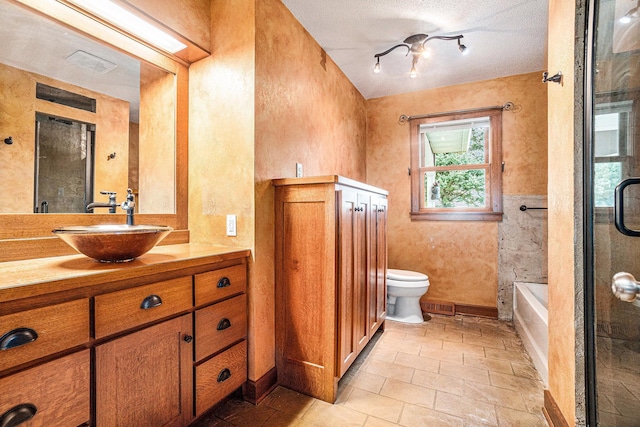 full bathroom with vanity, separate shower and tub, toilet, and a textured ceiling