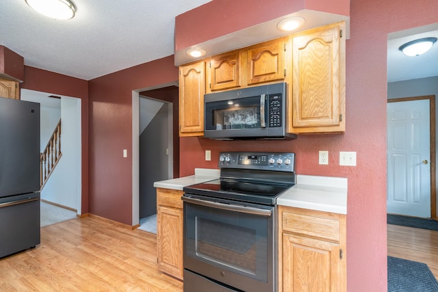 kitchen featuring black appliances and light wood-type flooring