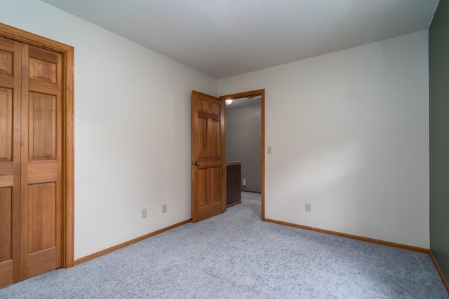 unfurnished bedroom with light colored carpet