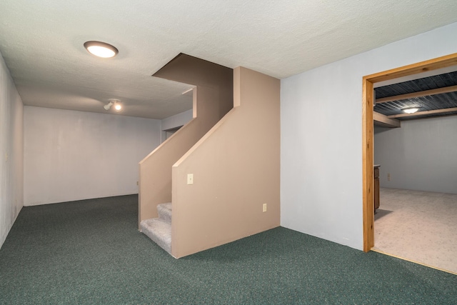 basement featuring a textured ceiling and carpet floors