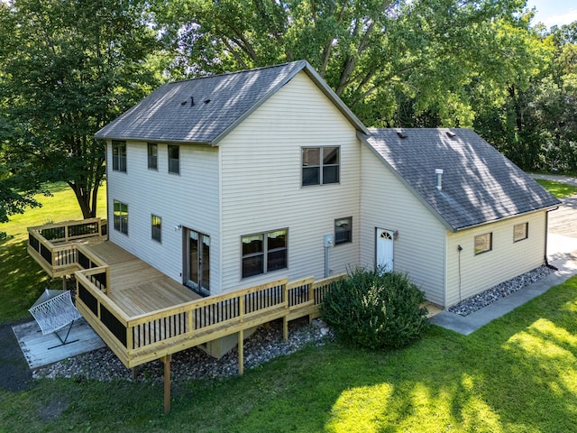 rear view of property with a lawn and a wooden deck