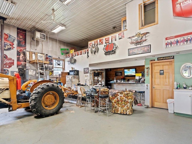 garage with ceiling fan and a workshop area