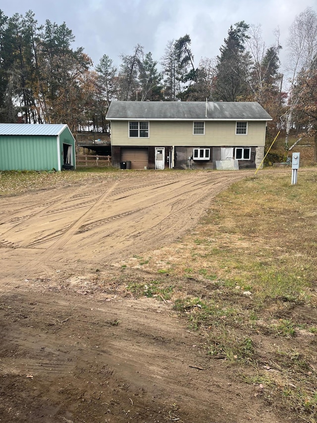 back of property featuring a storage shed