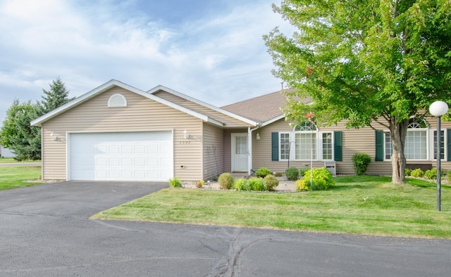 ranch-style home with a front yard and a garage