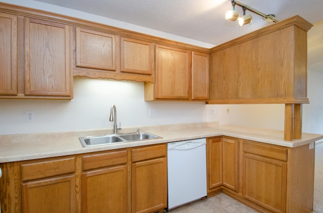 kitchen featuring rail lighting, dishwasher, a textured ceiling, and sink