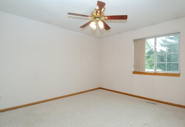 unfurnished room with ceiling fan and carpet floors