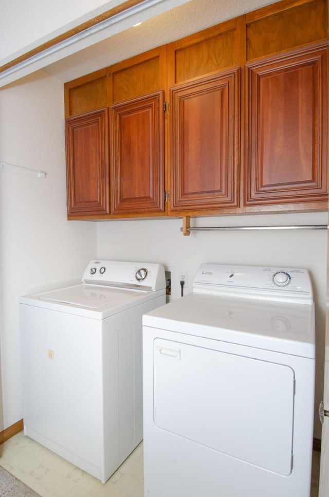 washroom with cabinets and separate washer and dryer