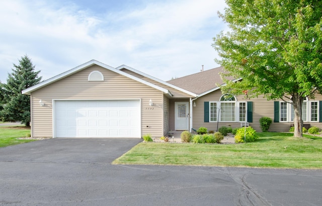 single story home featuring a garage and a front lawn