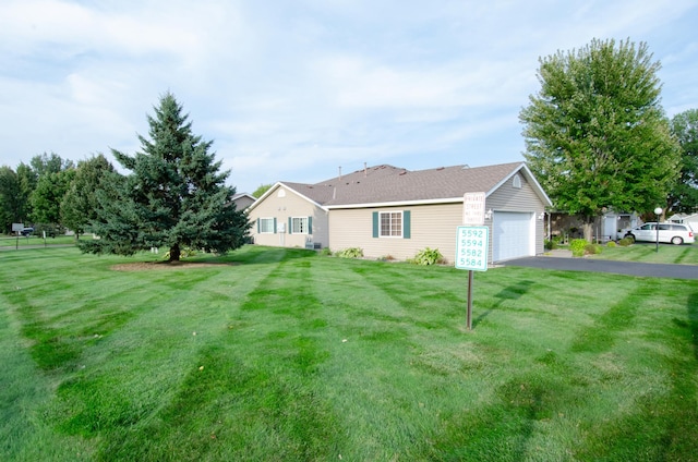 ranch-style house with a front yard and a garage