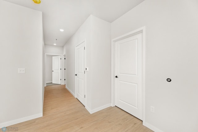 hallway with light hardwood / wood-style flooring