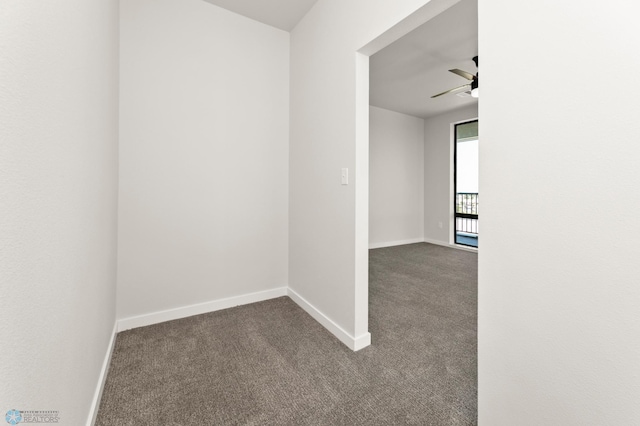 carpeted spare room featuring ceiling fan