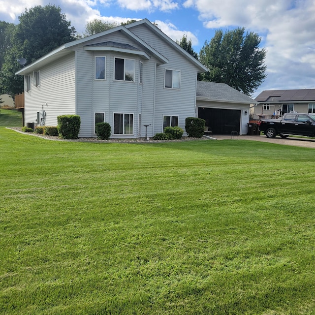 view of home's exterior featuring a lawn and a garage