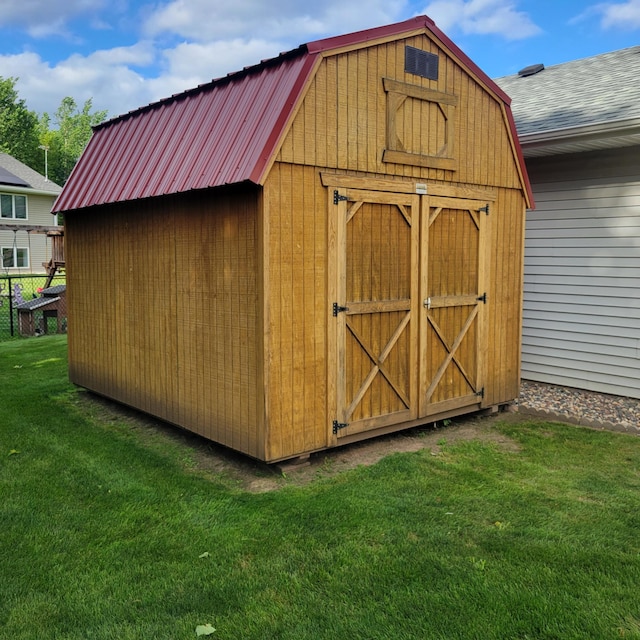 view of outdoor structure featuring a lawn