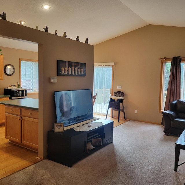 living room featuring light colored carpet and lofted ceiling